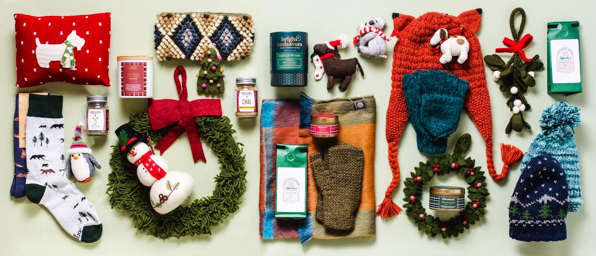A display of fair trade gift items from pillows to wreaths and hats.