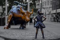 girl in front of bull statue wall street