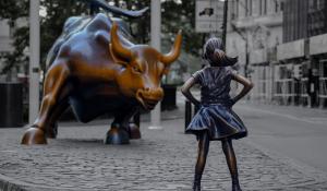 girl in front of bull statue wall street