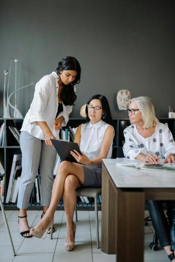 Three women looking at financial information
