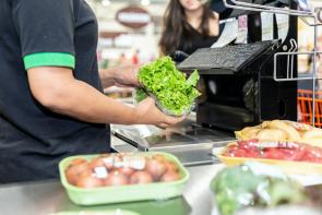 grocery store check out. produce packaged in plastic. reduce your waste foodprint with gardening.