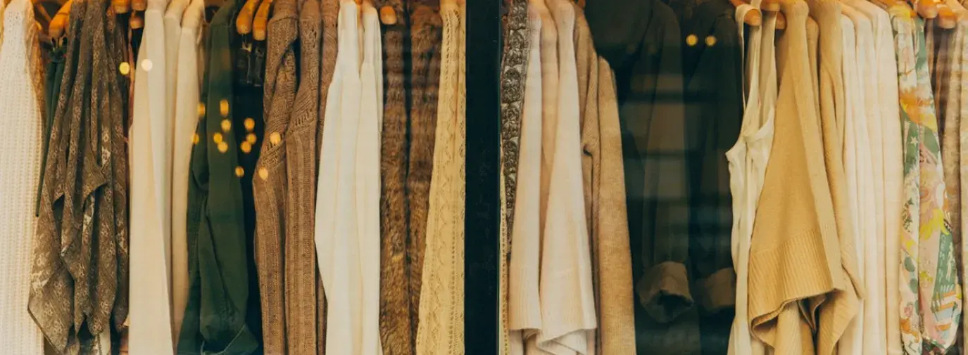 Image: clothing hanging on a store rack. Title: Carter's Responds to Calls to Remove Toxic Chemicals from Baby Clothes, Improve Sustainability Practices