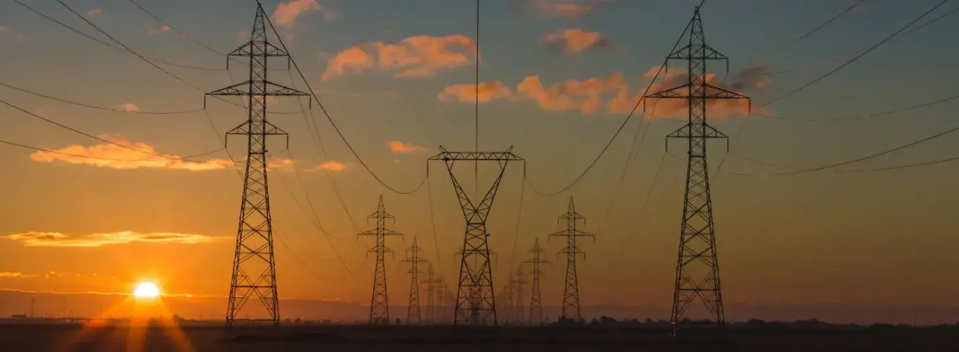 Image: telecom towers extend into the distance with a sunset in background. Title: Clean Energy is Calling Report, 2020 Edition 