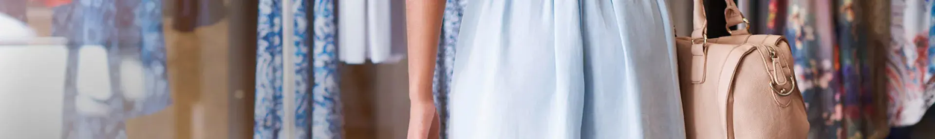 Image: woman holding shopping bags. Topic: Sustainable Shopping Tips