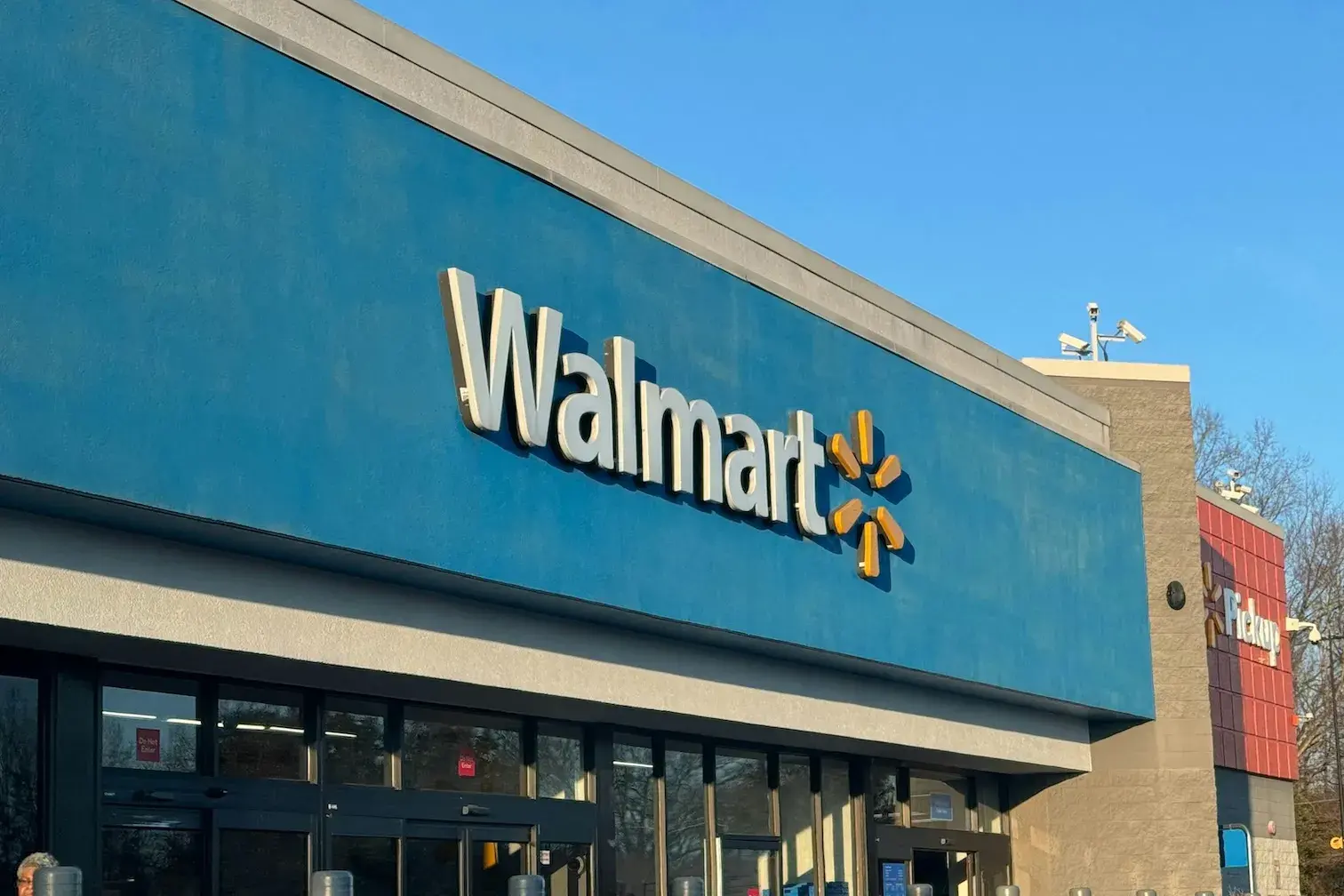 A Walmart sign above a Walmart store. 